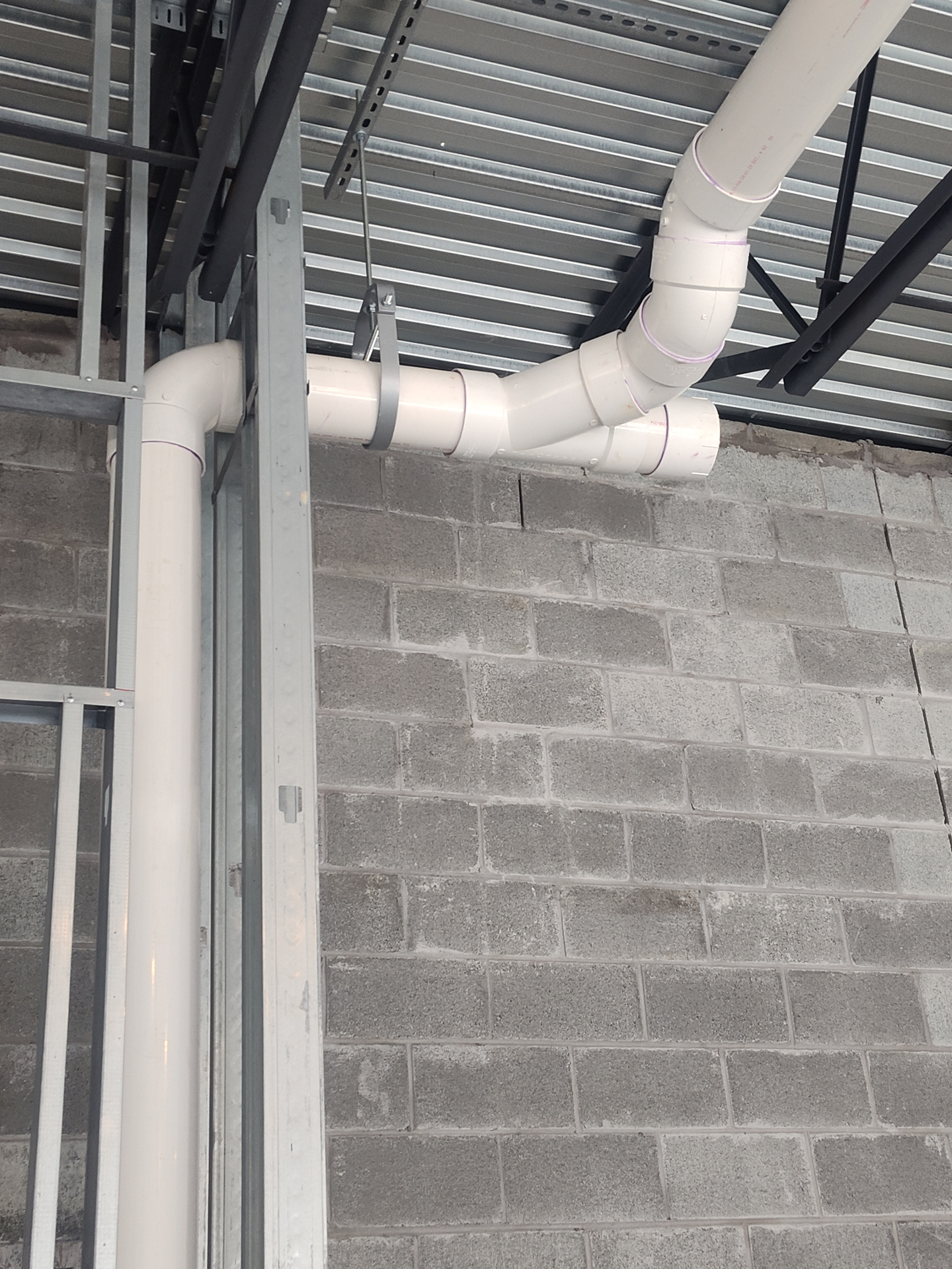 Overhead PVC drain system — commercial build